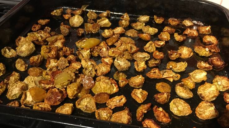 Oven dried wrinkly tomatilloes in baking tray