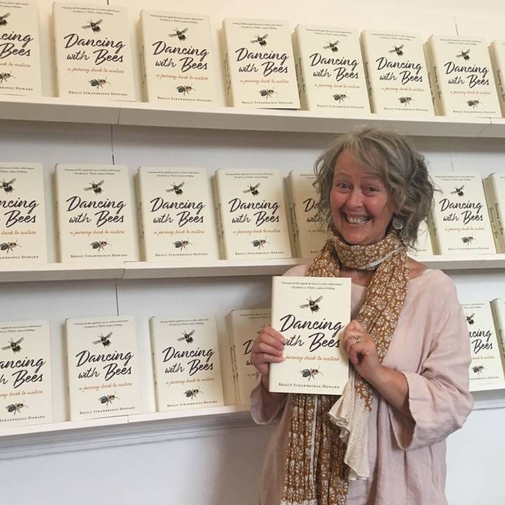 Photo of Brigit Strawbridge Howard with her book 'Dancing With Bees'