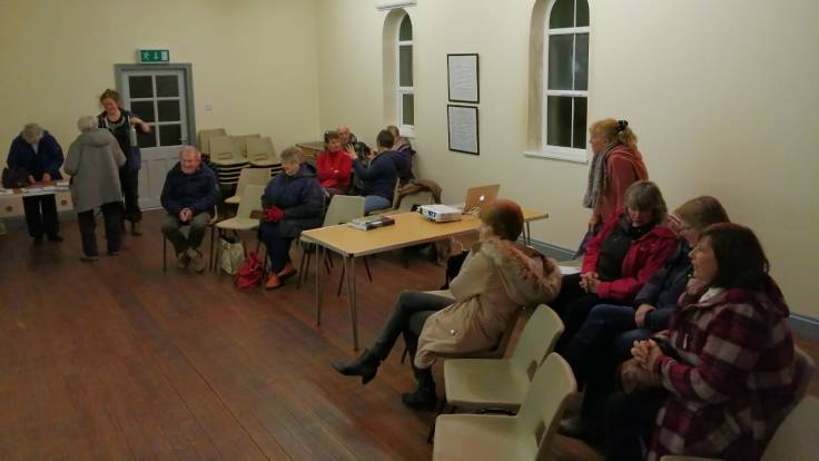 A dozen people in a small church hall