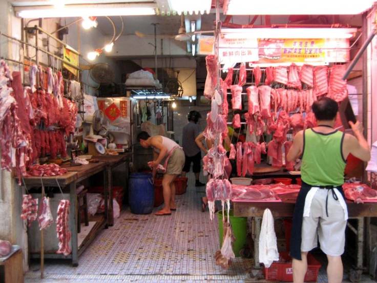 Lots of meat hanging up in an open shop, photo by FuriousGeorge1 on Wikipedia