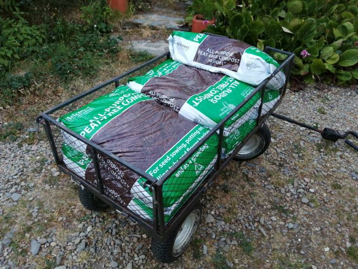 Cart with bags of compost