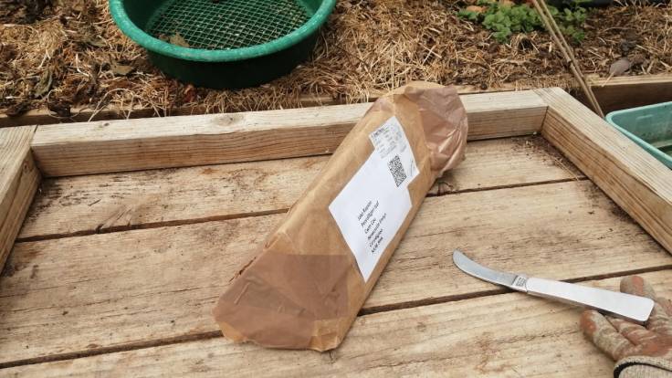 Toblerone shaped parcel next to garden knife