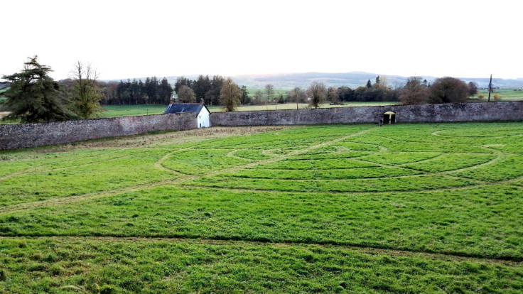 Circular paths in walled garden visible from top of a wall