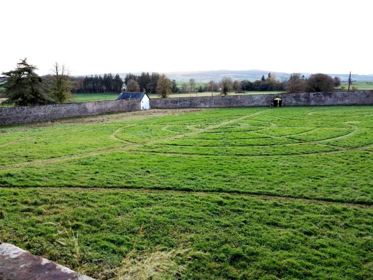 Circular paths in walled garden visible from top of a wall
