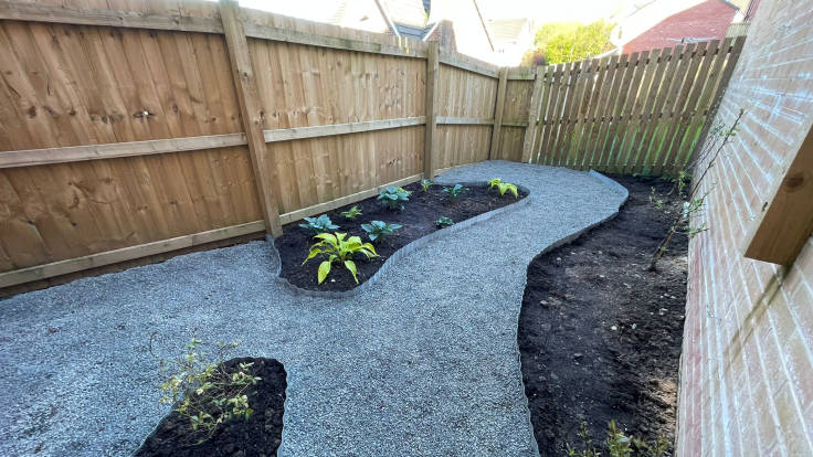 Landscaped back yard with paths and beds