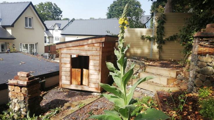 Newly built den with sloping roof, squeezed into a space behind the outdoor office