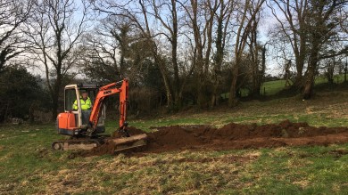 Digger scraping turf