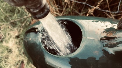 Filling watering can from tap