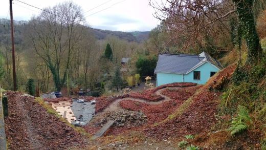 Outlines of paths in garden, blue house below & beyond