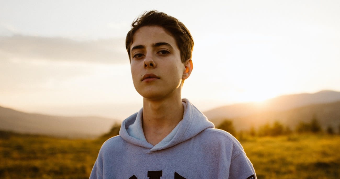 teenage boy staring at the camera