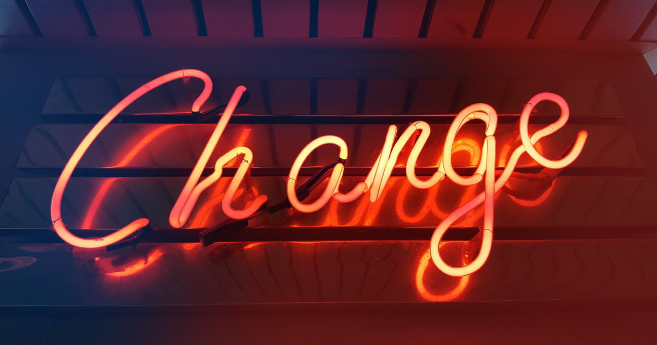 neon sign with the word change