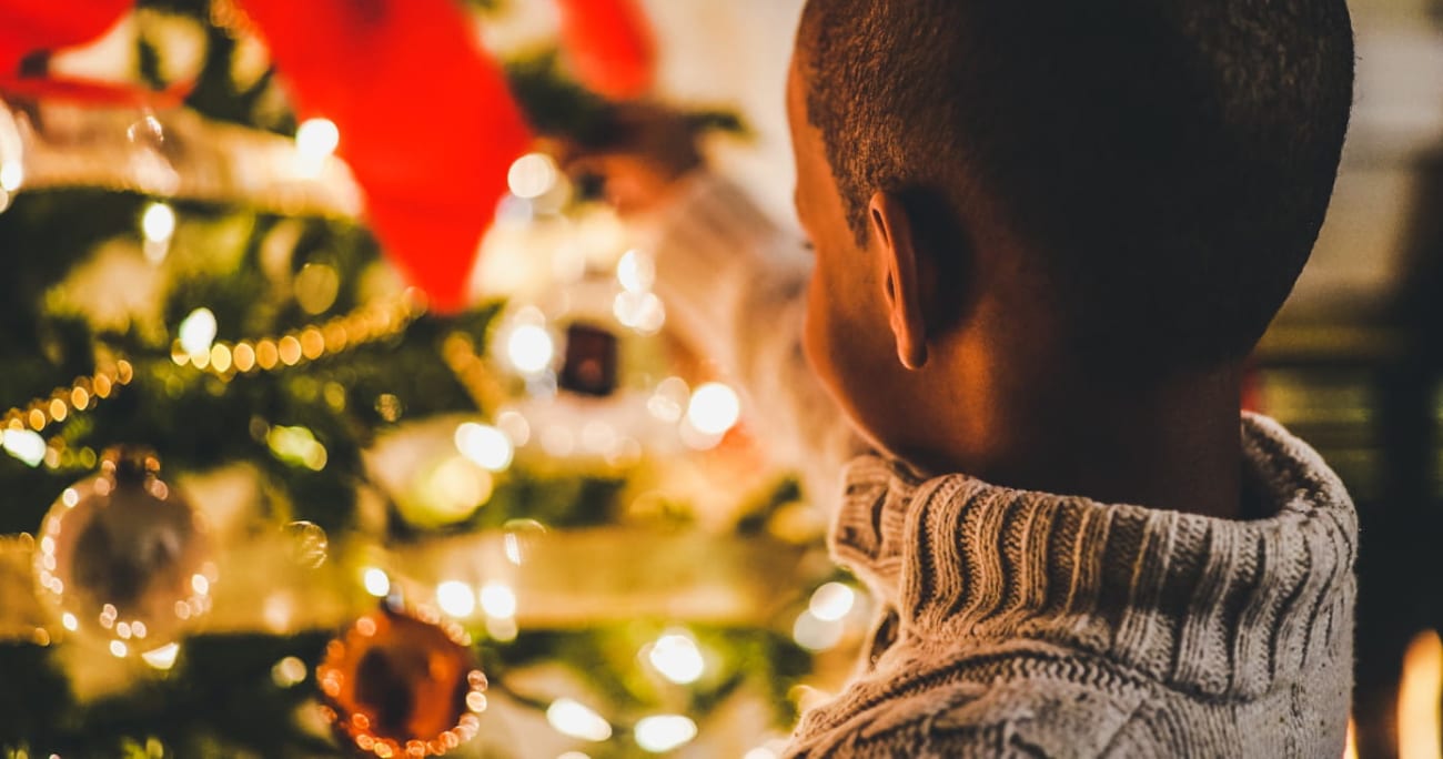 child looking at Christmas tree