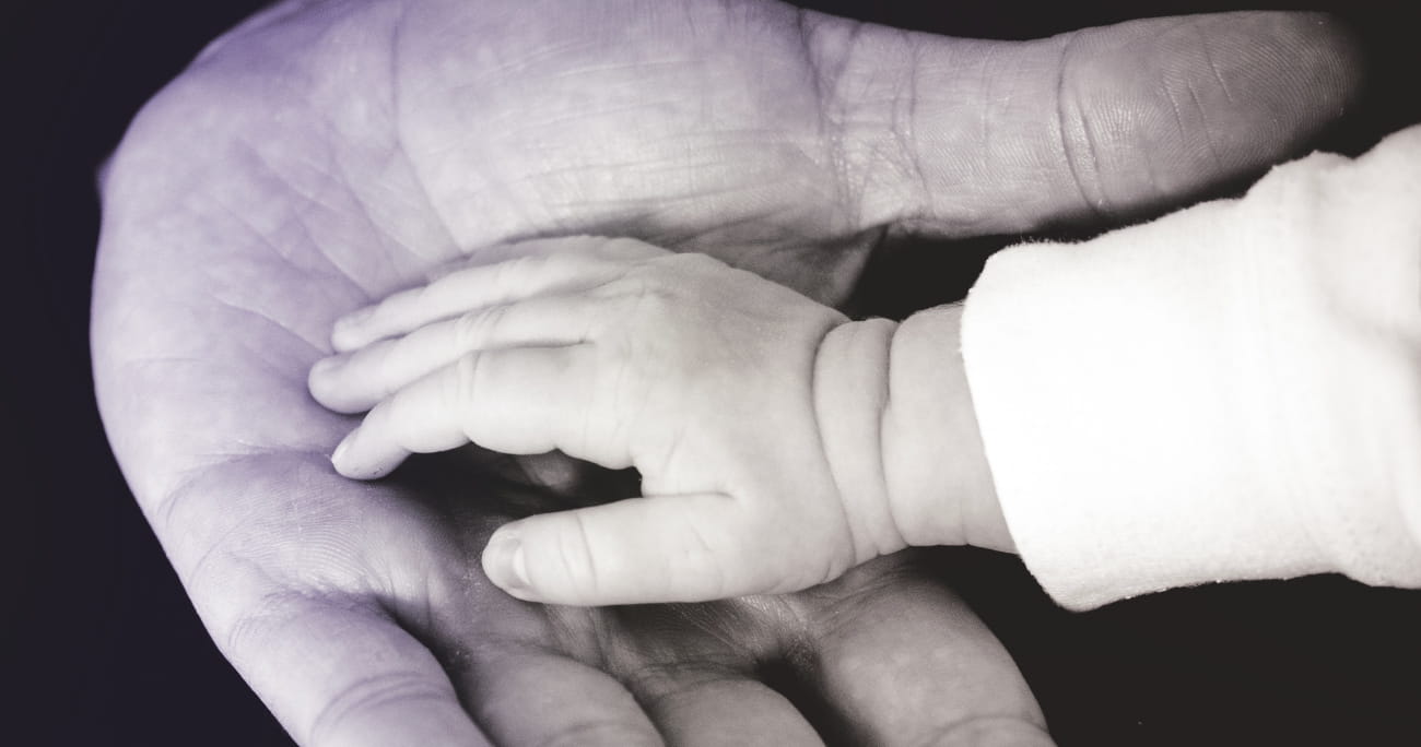 closeup of man holding child's hand