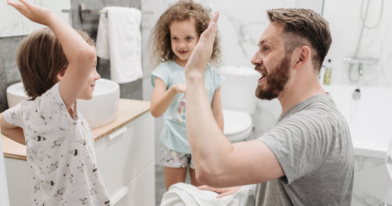 Dad giving his kids a high five