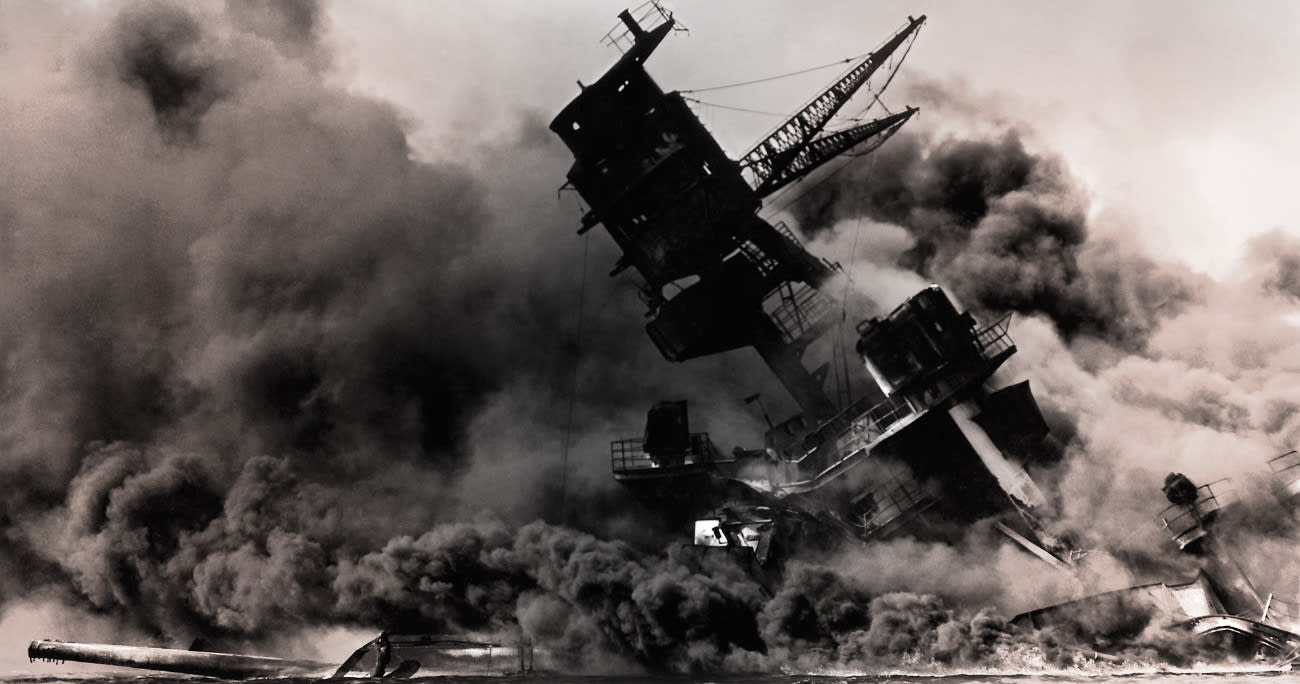 old, black-and-white photograph of a ship exploding in pearl harbor