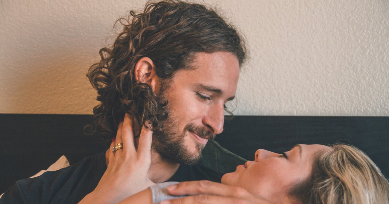 closeup of man holding woman and staring into her eyes