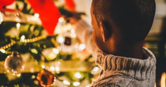 child looking at Christmas tree