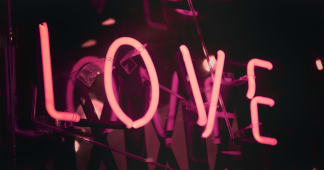 neon sign with the word love