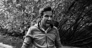 Man standing and yelling in anger