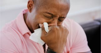 man in a pink shirt crying