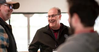 three men talking and laughing together