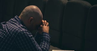 a father kneeling and praying