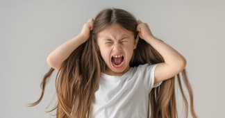 a young girl screaming with her hands over her ears
