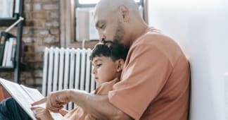 dad reading a book to his son