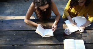 overhead view of two teen girls doing a Bible study
