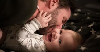 A father kissing his young child