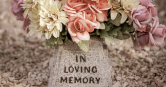 flowers on a tombstone header reading in loving memory