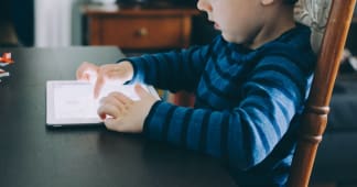 young child holding a tablet