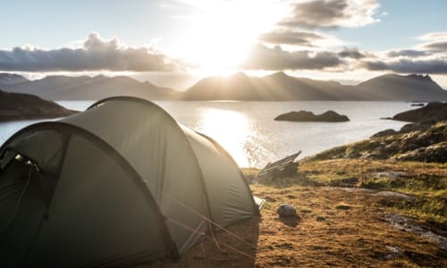 tent on the shore of a mountain lake
