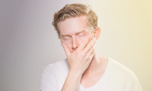 A man holding his face in discouragement