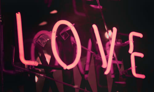 neon sign with the word love