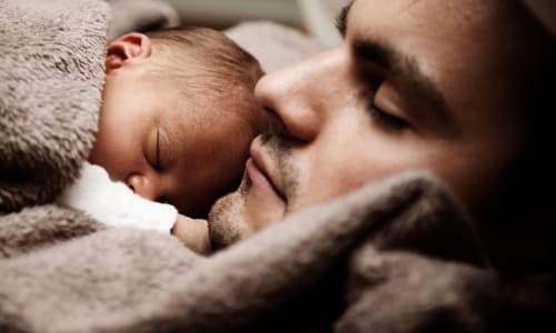 father holding sleeping baby | PublicDomainPictures, via Pixabay