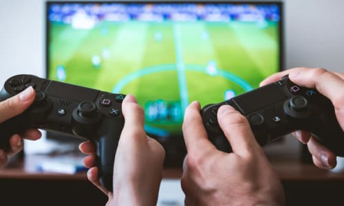 hands holding game controllers | JESHOOTS.COM, via Unsplash