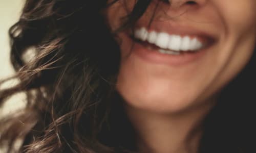 woman smiling with inspirational quote about self-love | Lesly Juarez, via Unsplash