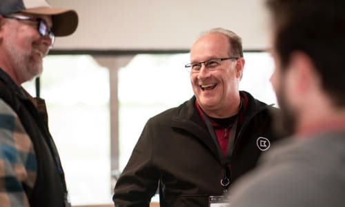three men talking and laughing together
