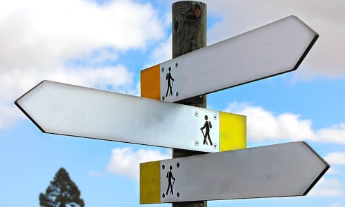road sign with three arrows pointing in different directions
