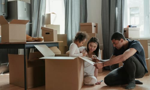 Family with moving boxes in the living room