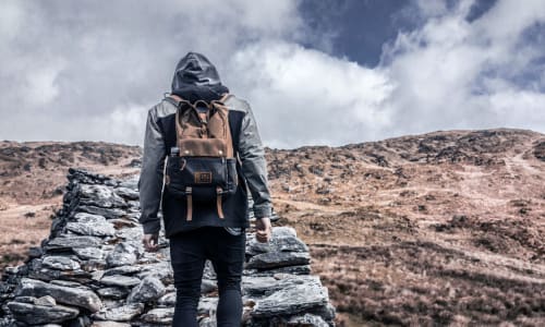Man walking up a hill alone