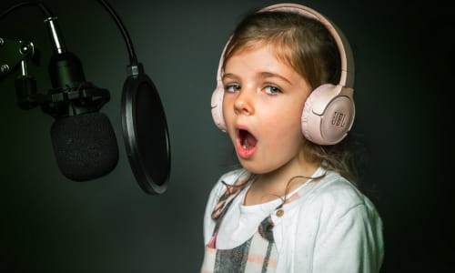 young child singing into a microphone