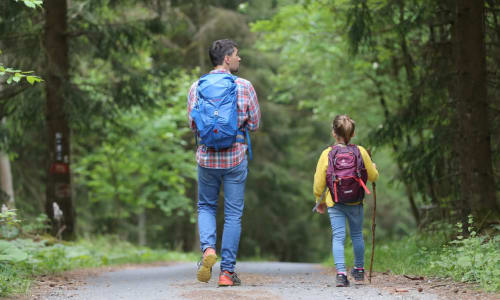 father and son walking on a path
