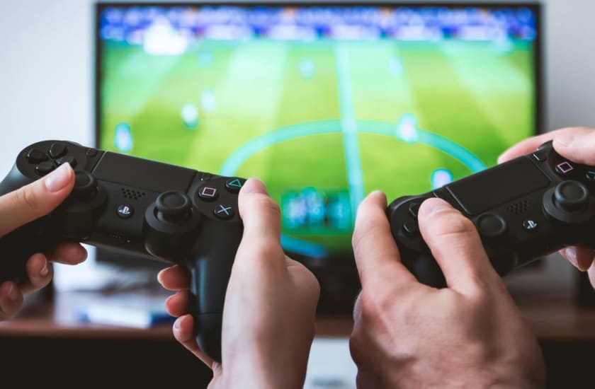 hands holding game controllers | JESHOOTS.COM, via Unsplash