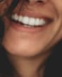 woman smiling with inspirational quote about self-love | Lesly Juarez, via Unsplash