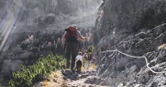 dad hiking in the mountains with his son