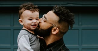 dad kissing his son’s cheek