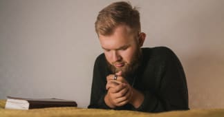 man kneeling and praying