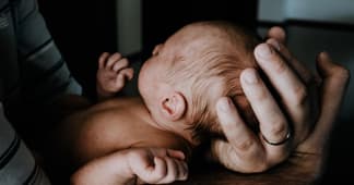 father holding newborn baby